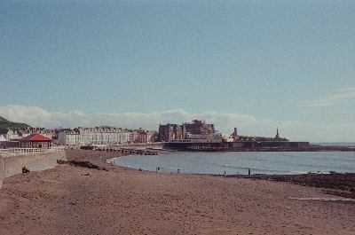 Aberystwyth's north beach, as seen from the promenade facing-south towards the Pier and Old College Building. Taken on 35mm film with a Kodak Retinette 1A.