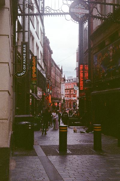 View of the Cavern Quarter on Mathew Street, Liverpool, taken from N John St.. Just on the right behind the Sgt. Peppers bar is the entrance to the official Cavern Club. Taken on 35mm film with a Kodak Retinette 1A.